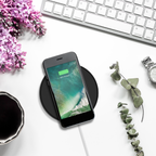 Phone charging on the black Juice 10W wireless charging pad