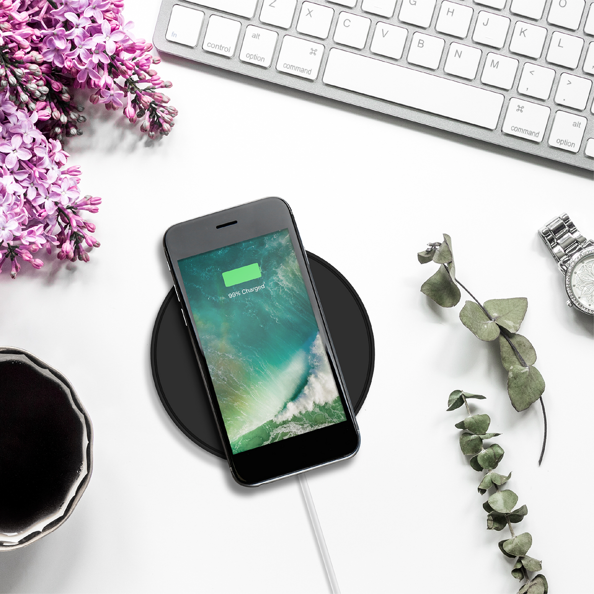 Phone charging on the black Juice 10W wireless charging pad