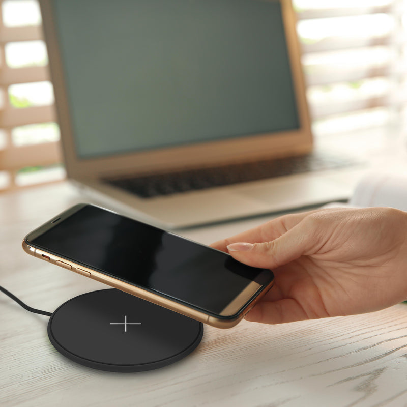 Juice 10W Wireless Charging Pad on Desk, hand placing phone onto charging pad.